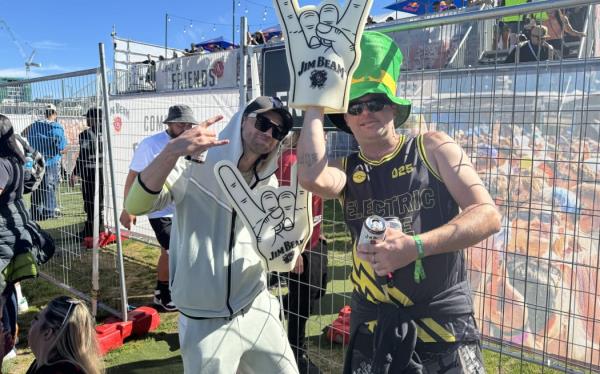 Two people with giant foam hands posing for the camera.